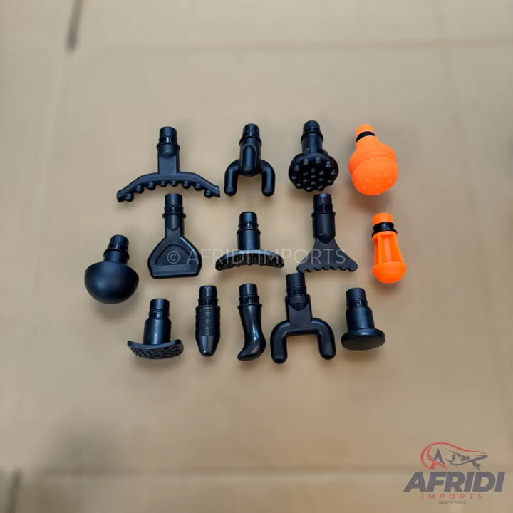 A collection of black and orange massage gun attachments.