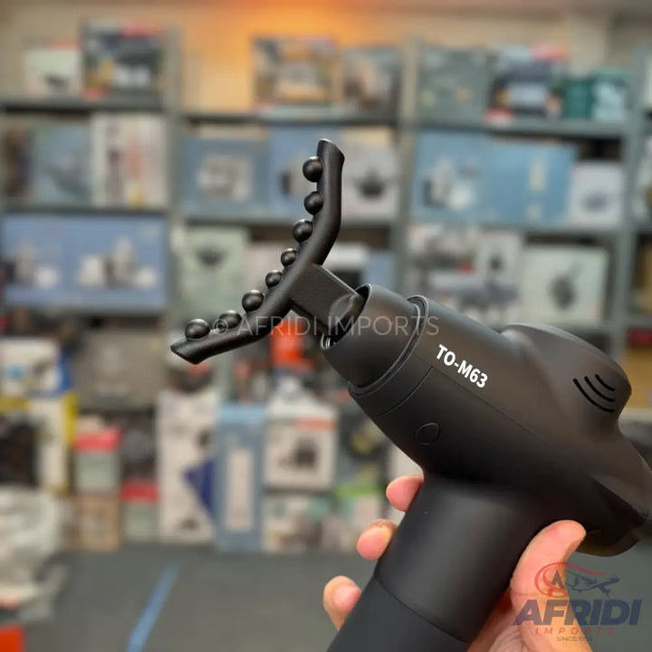 Black handheld massage gun with a unique, flexible U-shaped attachment featuring multiple small, spherical nodes.