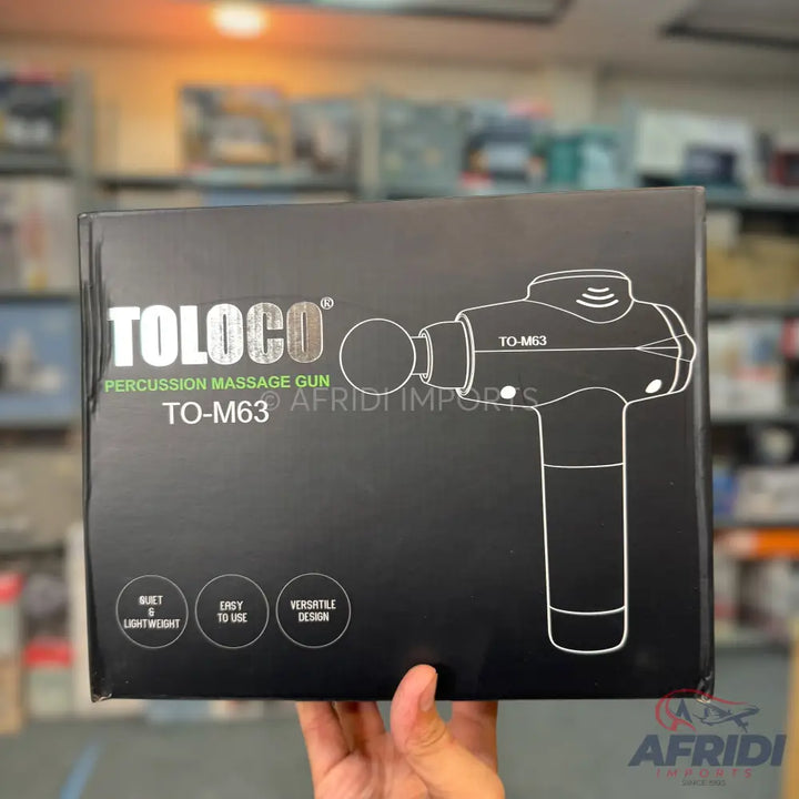 Black box for a Toloco Percussion Massage Gun (Model TO-M63) highlighting features like ’quiet & lightweight,’ ’easy to use,’ and ’versatile design.’