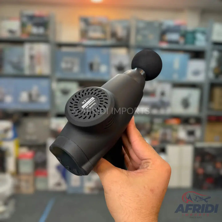 A black handheld massage gun with a spherical head attachment.