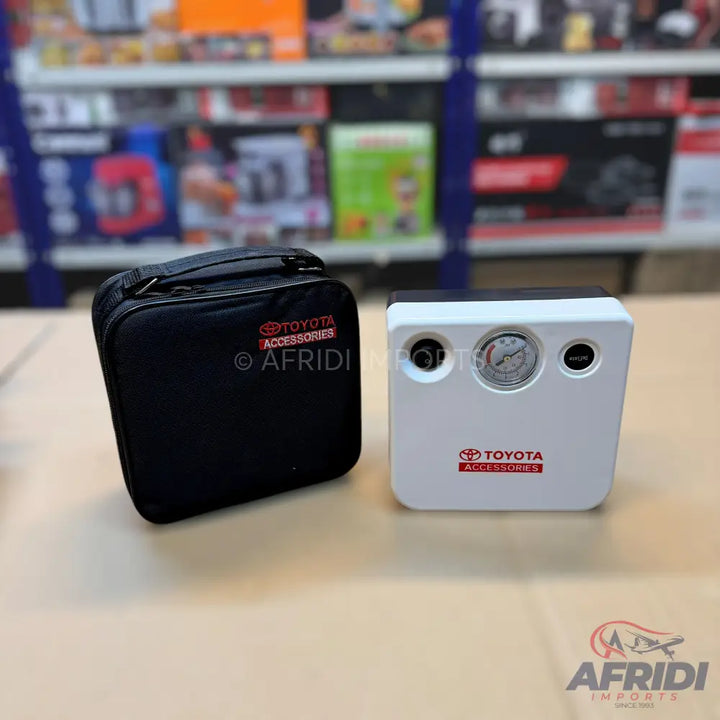 White portable car tire inflator with a pressure gauge and a black carrying case.