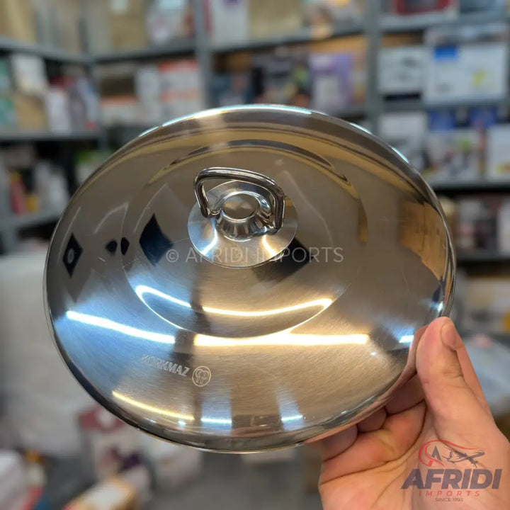 Shiny stainless steel pot lid with a metal loop handle.
