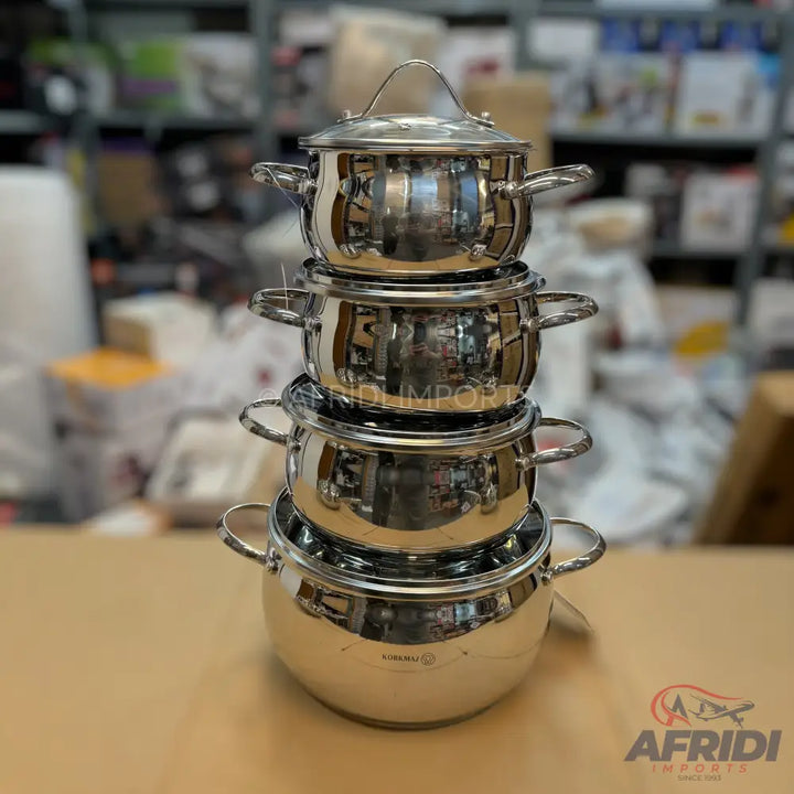 A nested set of four stainless steel cooking pots with lids.