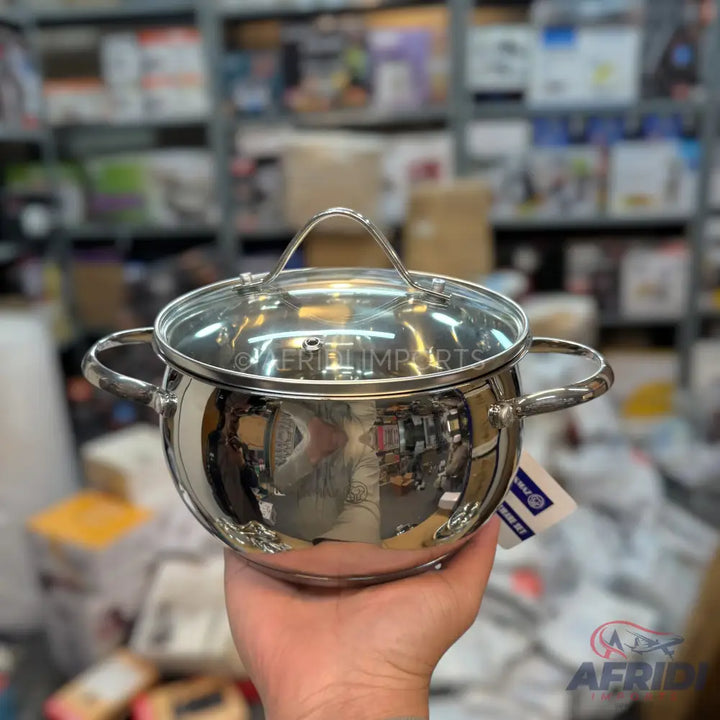A stainless steel cooking pot with a glass lid and two handles.