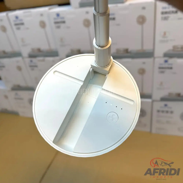 White, circular base of a telescopic stand with control buttons.