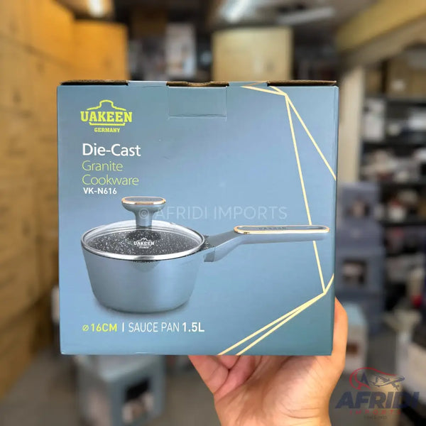 Blue-grey die-cast granite saucepan with a glass lid and a silver handle.