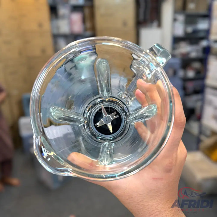 Clear glass blender jar with a four-blade assembly at the bottom.