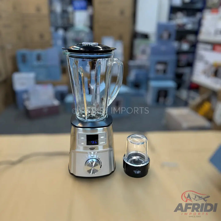A silver blender with a glass pitcher and a smaller grinding cup.