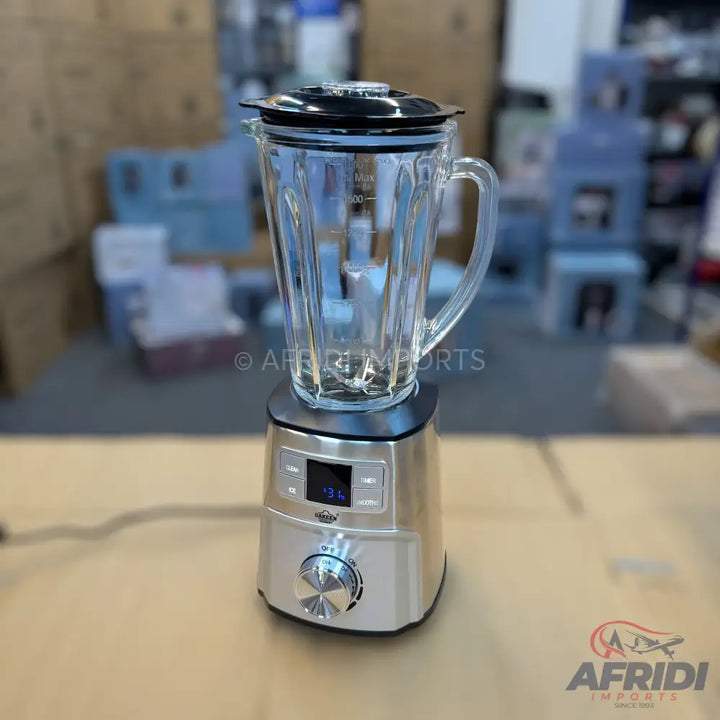 A silver and black blender with a clear glass pitcher and digital controls.