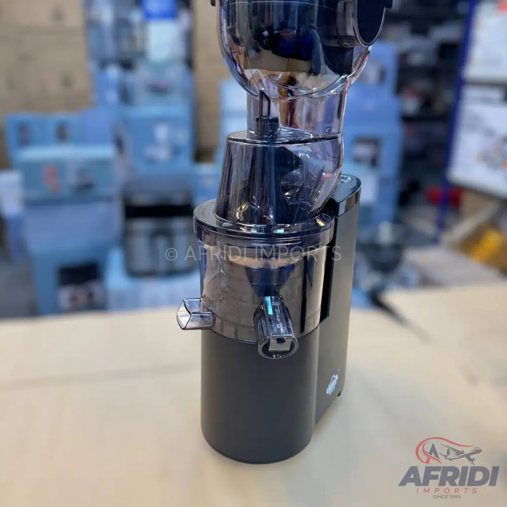 A black cold press juicer with transparent components.