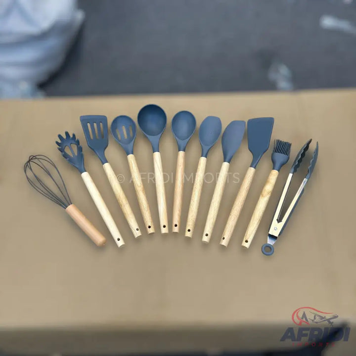 A set of kitchen utensils with blue silicone heads and light wooden handles.