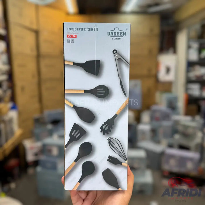 A set of 12 silicone kitchen utensils with wooden handles.