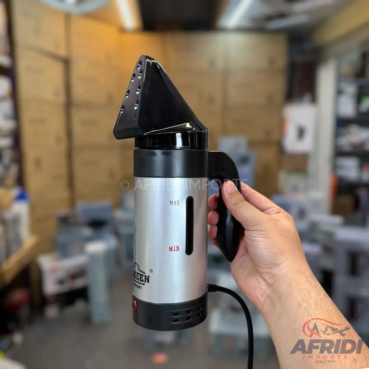 Handheld garment steamer with a silver body, black handle, and a transparent water level indicator.