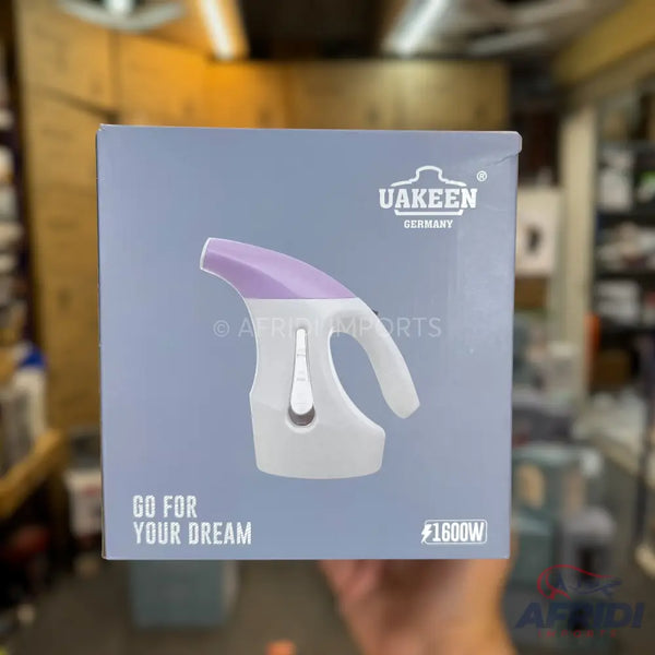 Box for a handheld clothing steamer with a purple top and white body, advertising 1600W power.