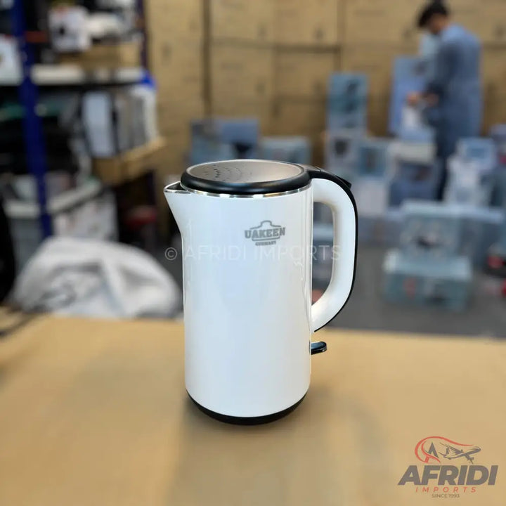 White electric kettle with a black handle and lid.