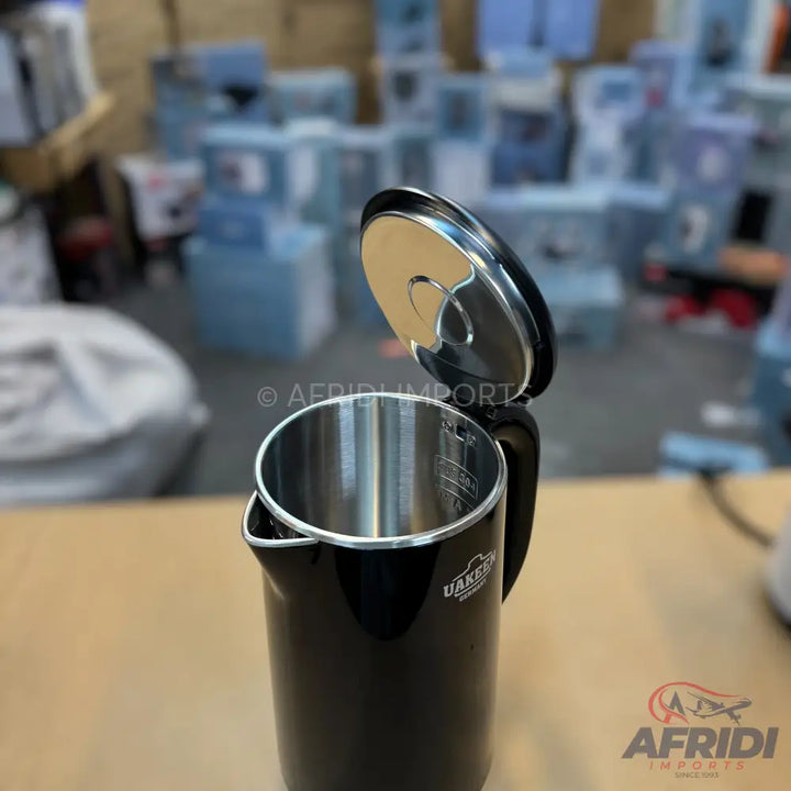 Black electric kettle with an open lid and stainless steel interior.