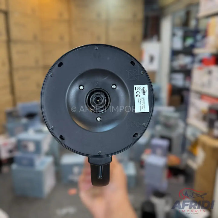 Black electric kettle base with a central connector and power specifications.