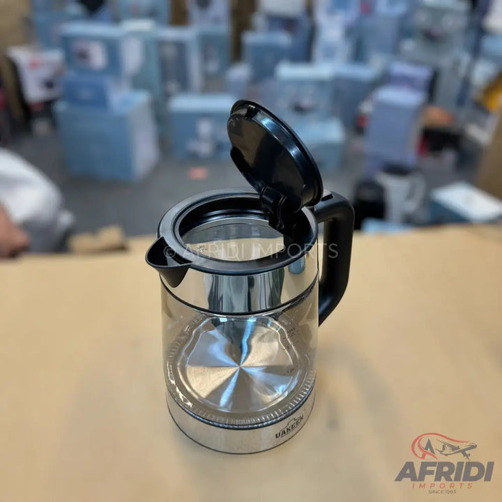 A clear glass electric kettle with a black lid and handle, and a polished metal base.