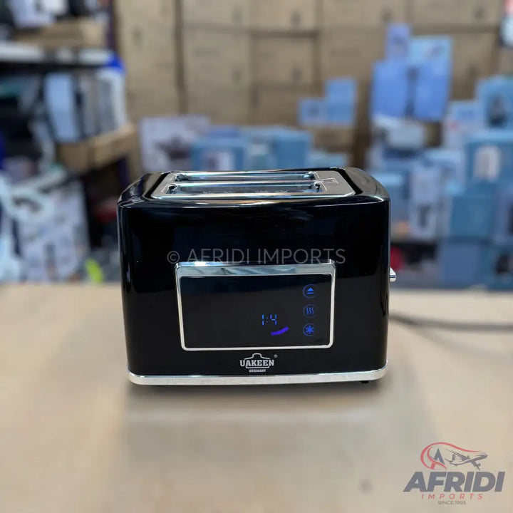 A black, two-slice toaster with a digital display and chrome accents.