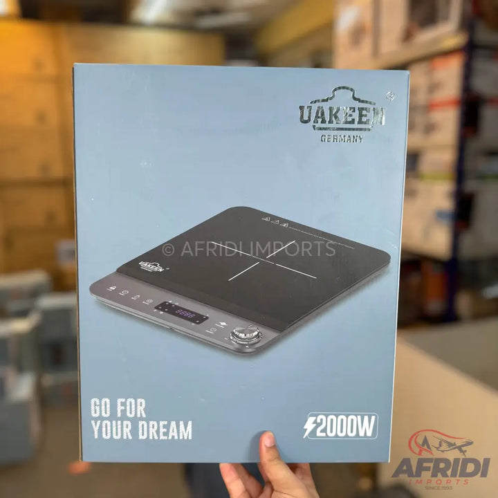 Box containing a portable induction cooktop.