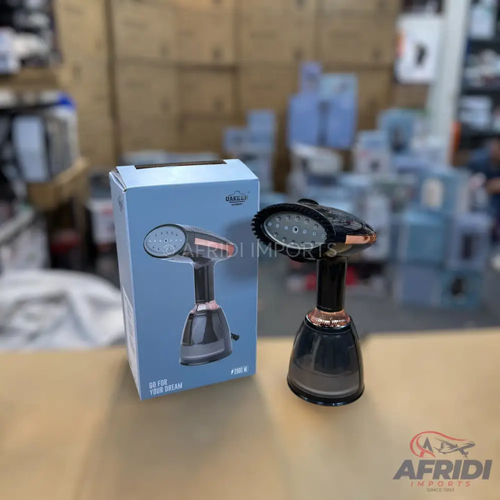 A handheld garment steamer with a black body, rose gold accents, and a clear water tank.