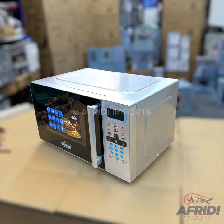 A modern white microwave oven with a black door and digital controls.