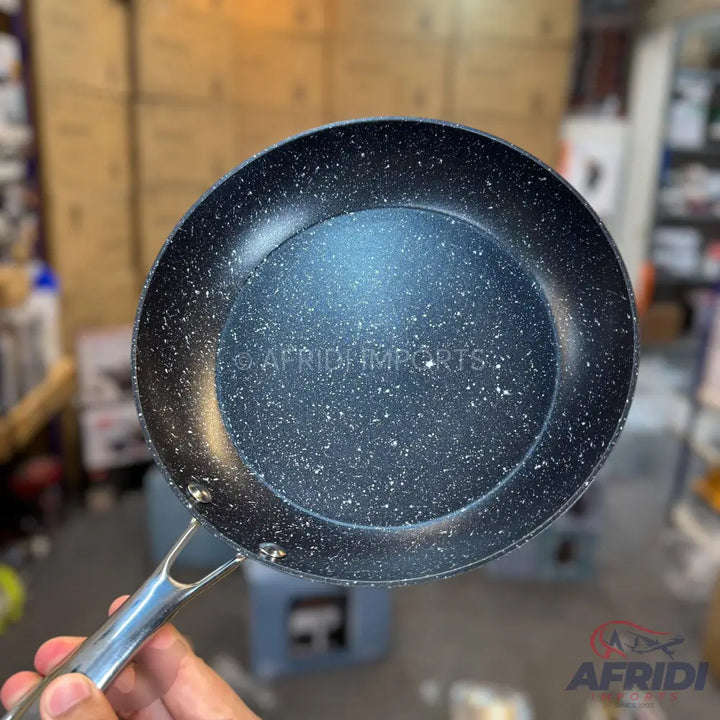 Black, speckled non-stick frying pan with a silver handle.