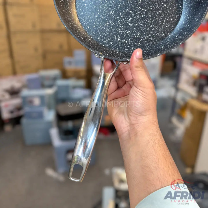 Black speckled non-stick frying pan with a silver metal handle.