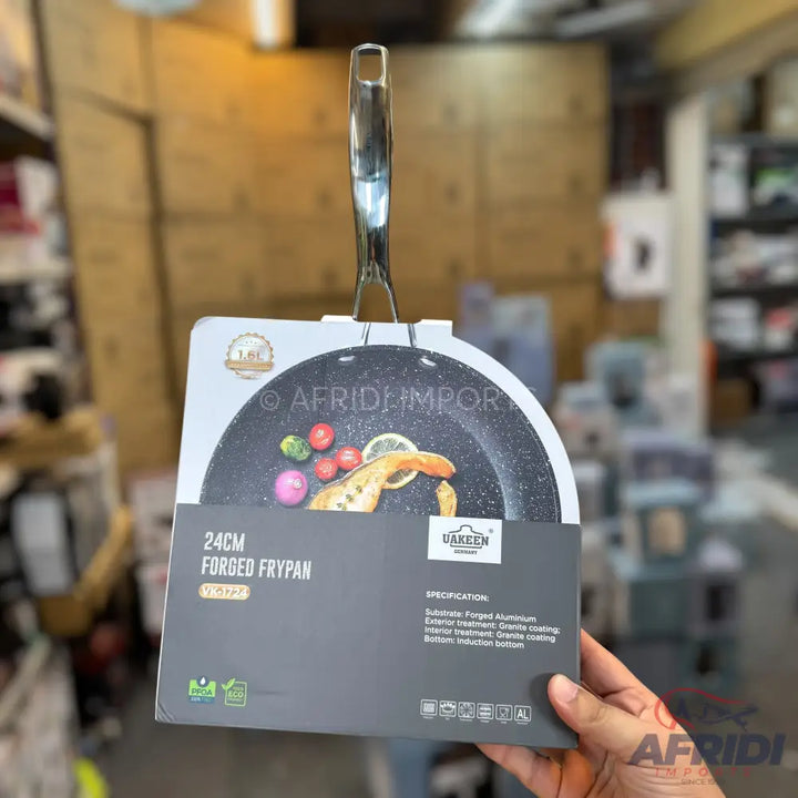 A black speckled frying pan with a metallic handle, featuring a non-stick granite coating and suitable for induction cooktops.