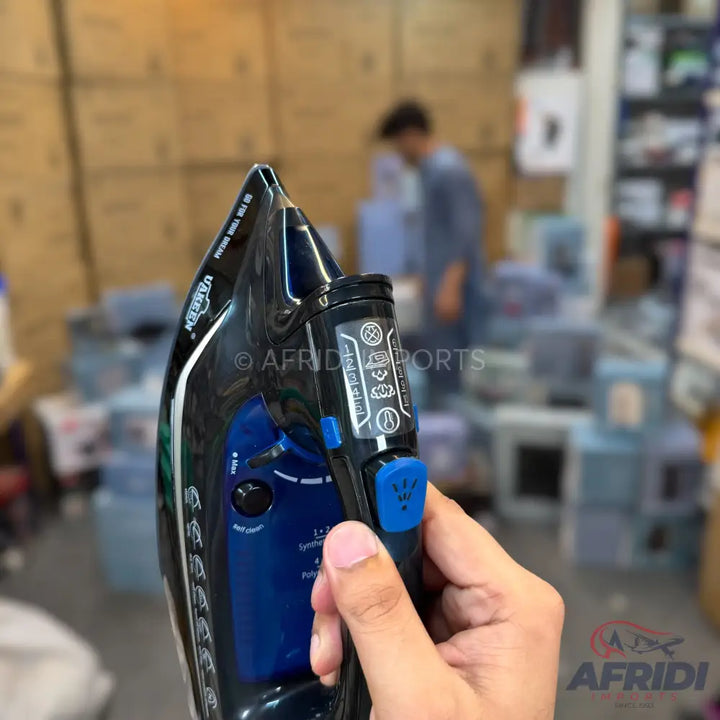 A black and blue steam iron with a digital display and ergonomic handle.