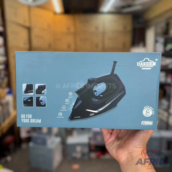 A black steam iron with a ceramic soleplate and various features.