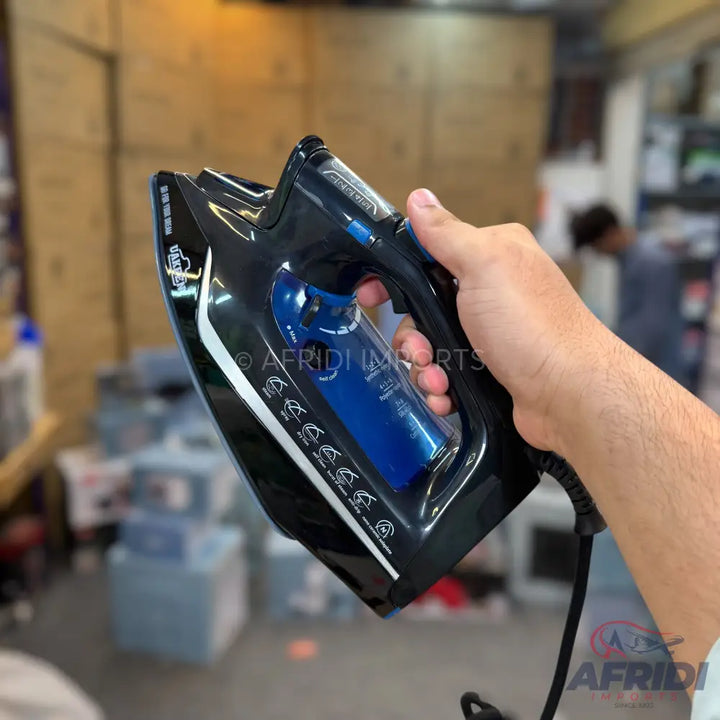 A black and blue steam iron with a textured grip.
