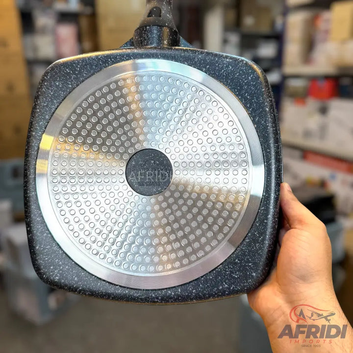 Black granite-effect square pan with a dimpled metallic base.