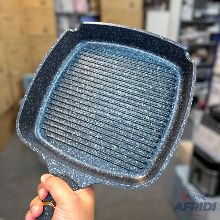 A dark gray speckled non-stick square grill pan with ridges.