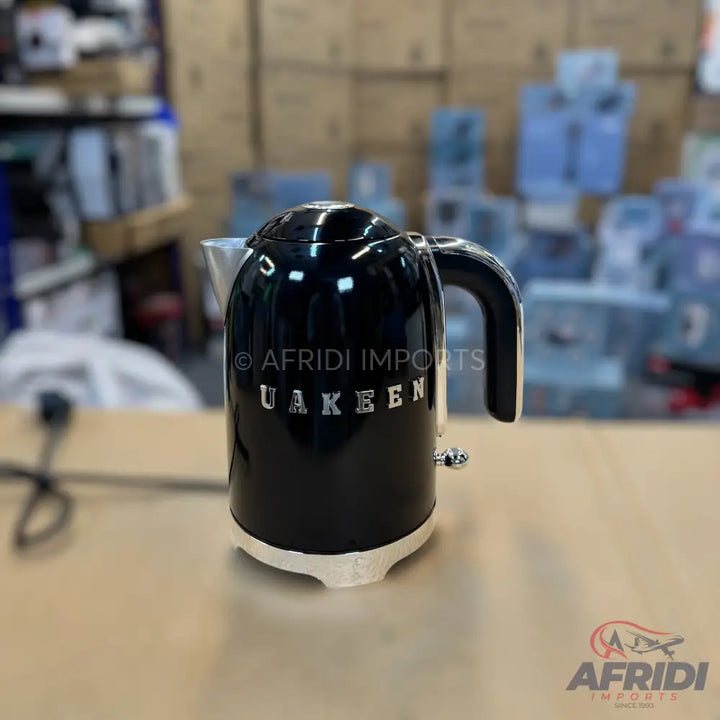 Black electric kettle with a white base.