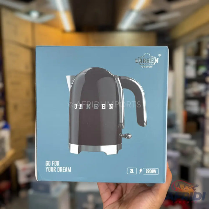 A charcoal gray electric kettle with a chrome handle and base, featuring a 2-liter capacity and 2200W power.