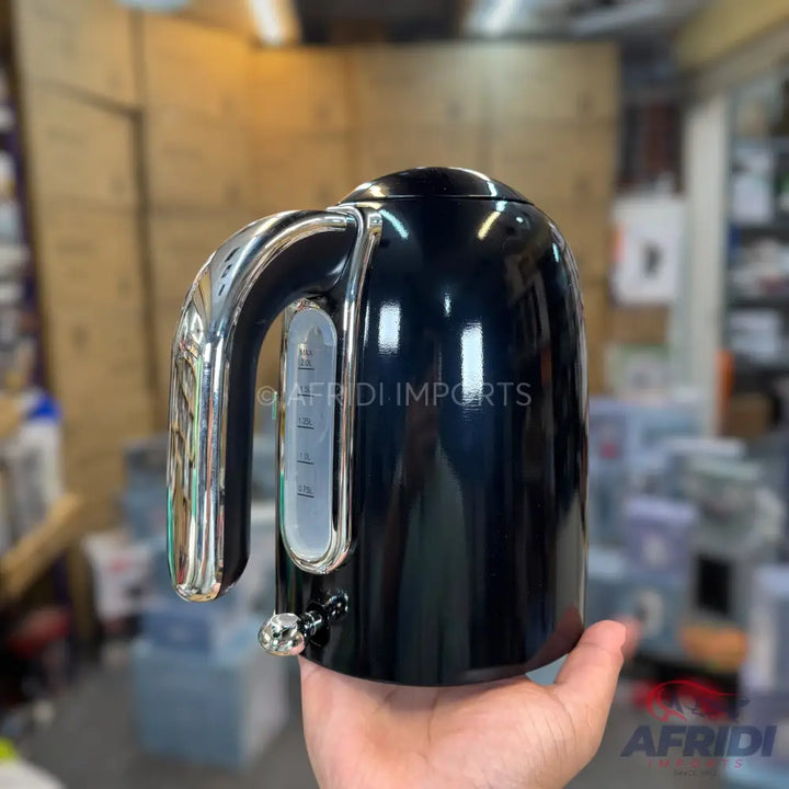Glossy black electric kettle with a chrome handle and water level indicator.