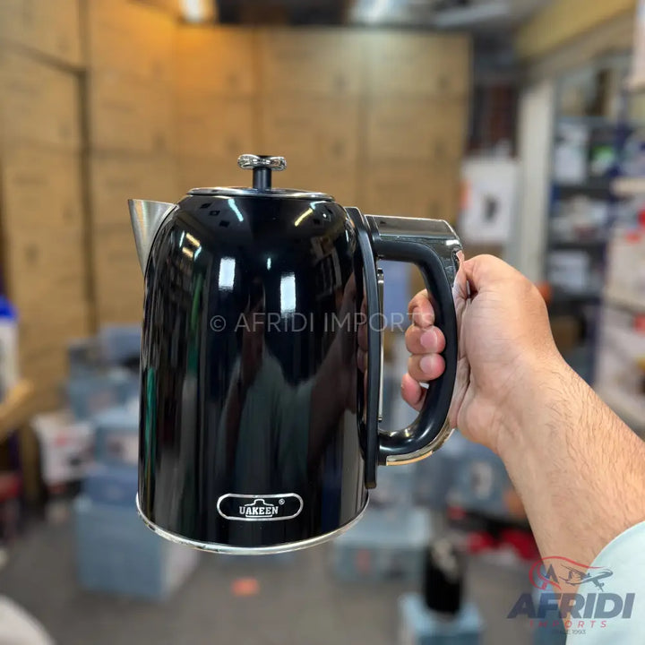 A black electric kettle with a silver spout and base.