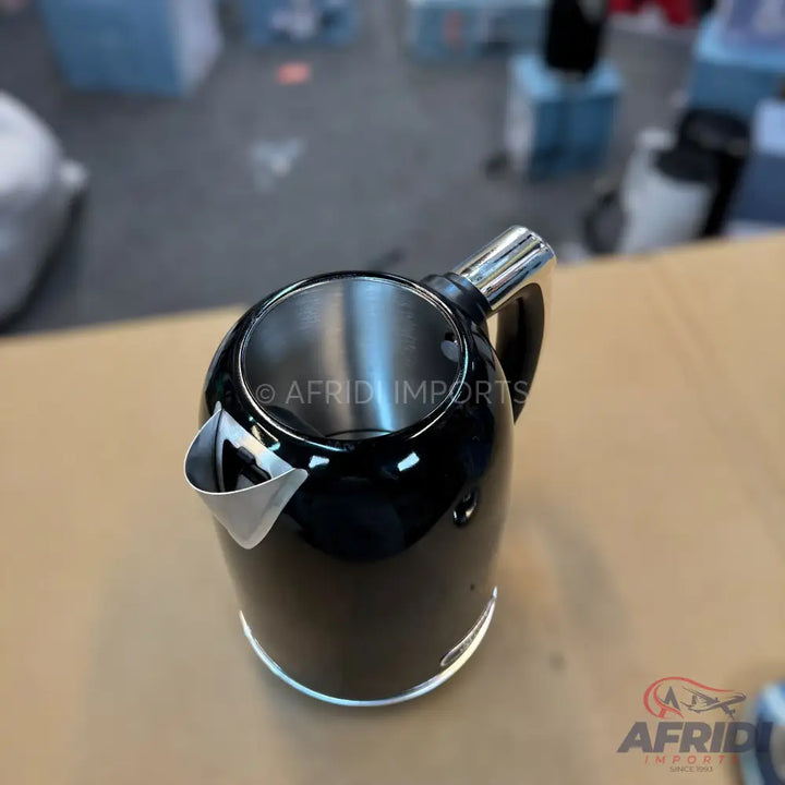 Black electric kettle with a stainless steel interior and spout.
