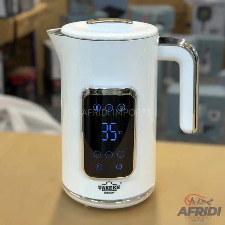 White electric kettle with digital temperature display and controls.