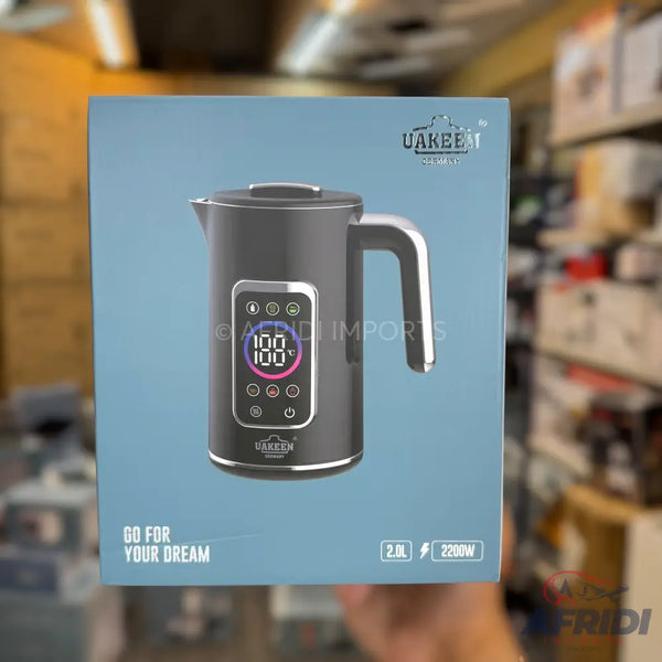 A gray electric kettle with a digital display showing a temperature of 100 degrees Celsius and various function icons, capable of holding 2.0 liters and operating at 2200 watts.