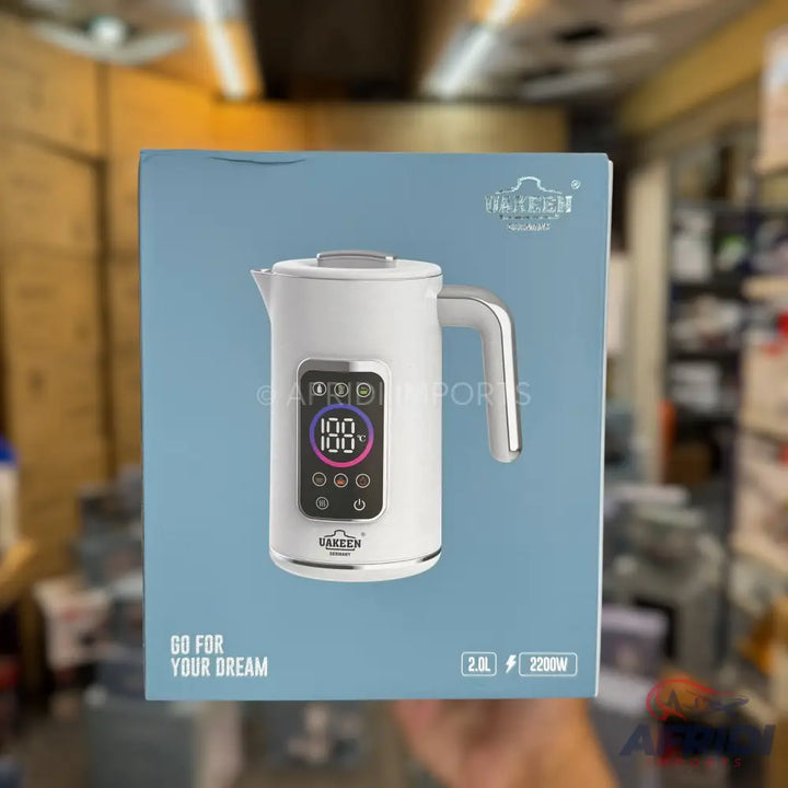 White electric kettle with a digital display and temperature controls.