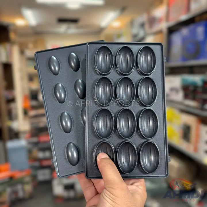 A two-part non-stick baking mold for making nut-shaped cookies.