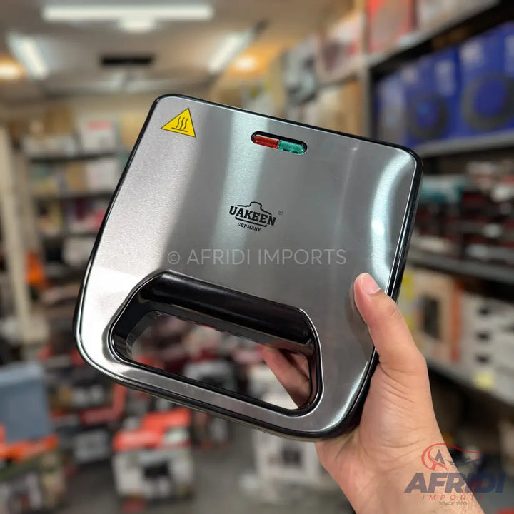 Stainless steel sandwich maker with heat indicator lights.