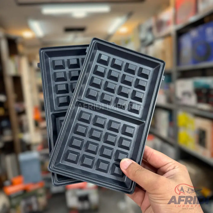 Two removable, non-stick waffle maker plates with square grids.