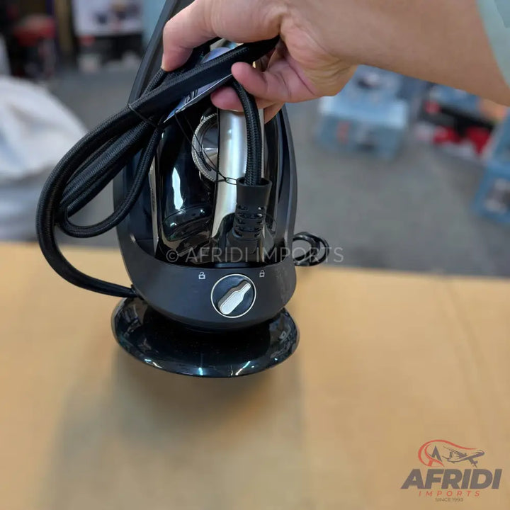 Black garment steamer with a silver and black control dial.