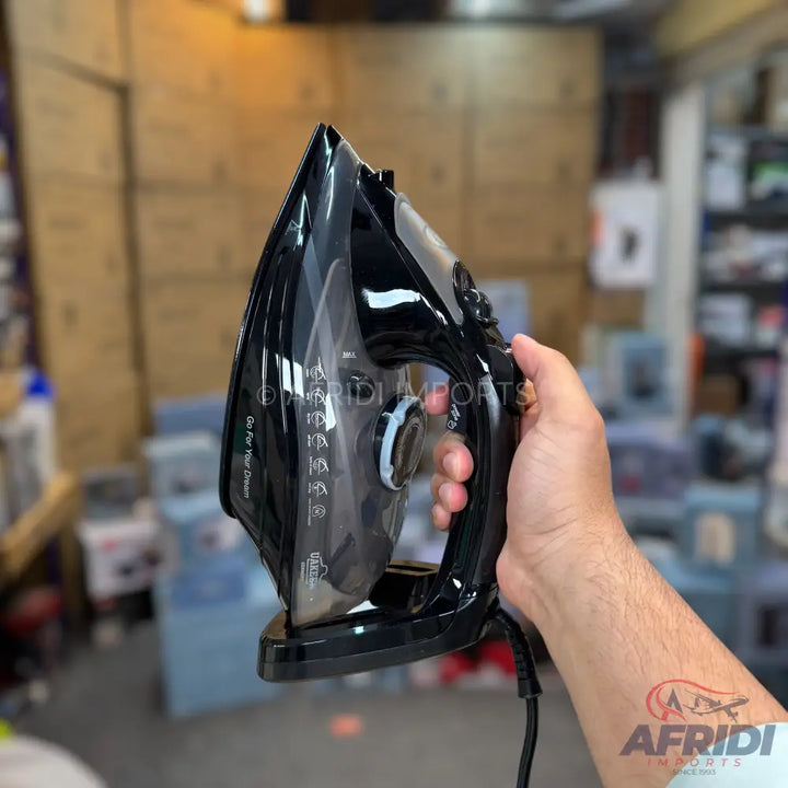 Black steam iron with a clear water tank and ergonomic handle.