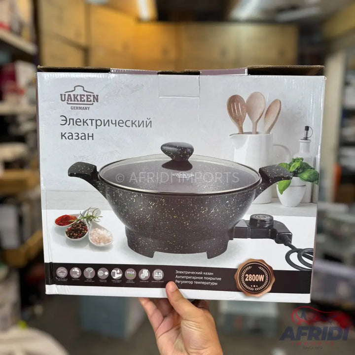 An electric kazan (cooking pot) with a speckled black finish, a glass lid, and a detachable thermostat control, rated at 2800W.