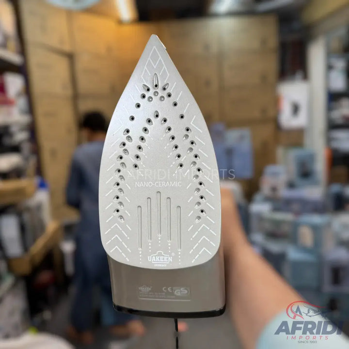 Silver-grey steam iron with a ceramic soleplate.