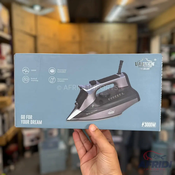 Boxed iron with a black and silver design, featuring a ’GO FOR YOUR DREAM’ slogan and a 3000W power rating.